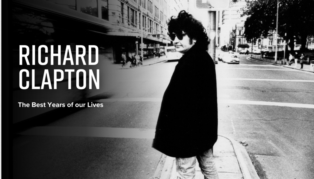 Black and white photo of a man in sunglasses and dark coat standing on a city street corner. Text reads "Richard Clapton - The Best Years of our Lives.