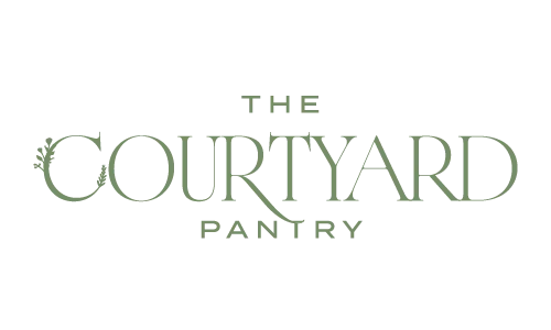 Logo for "The Courtyard Pantry" with green serif lettering and small leaf accents on the letter "C.