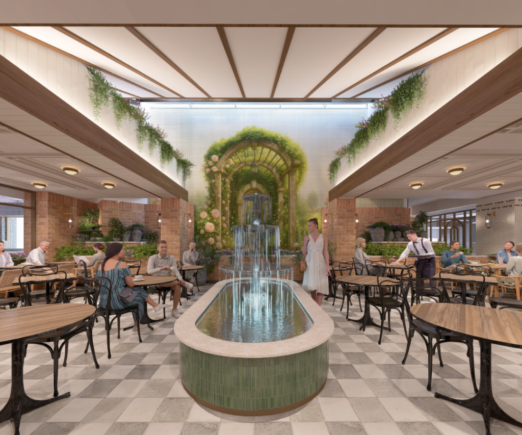 Indoor café with checkered floor, central water fountain, greenery, and people seated at tables; a large decorative arch with plants and a waterfall is featured at the back.